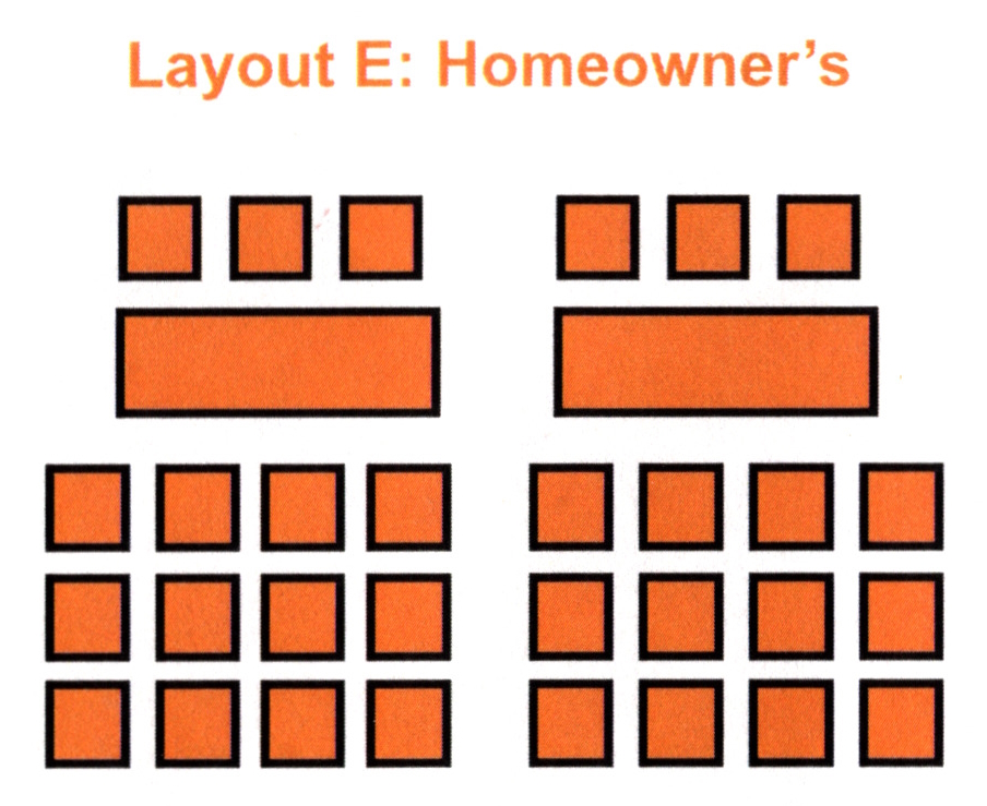 Two tables at front with a few chairs behind them. Rows of chairs facing the front