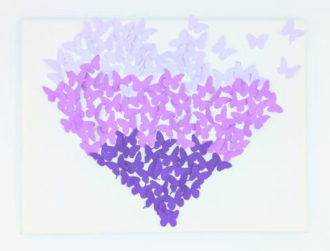 Purple butterflies forming a heart on a canvas