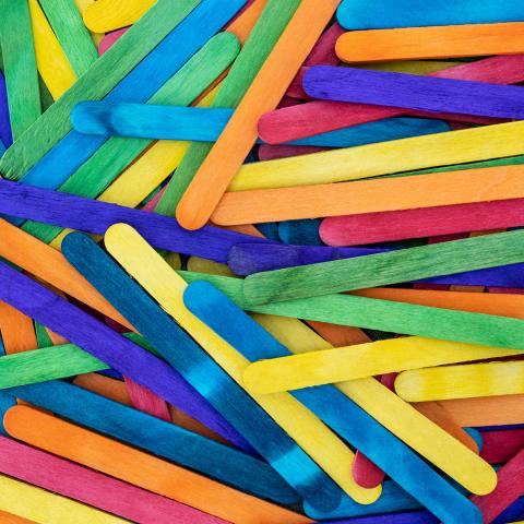 colorful popsicle sticks in a messy pile