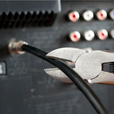 cable cord being cut from back of television set