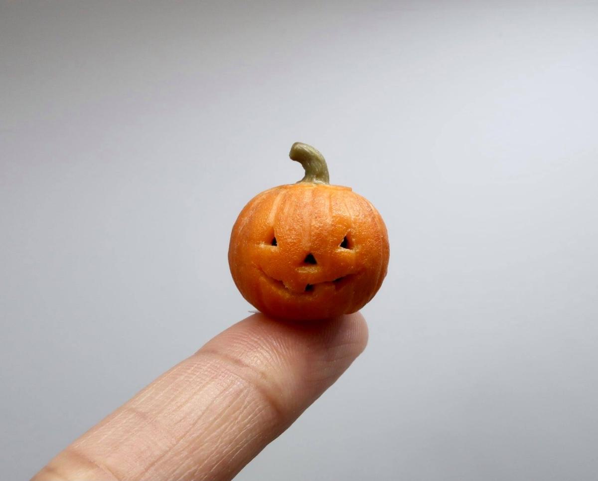 miniature pumpkin on a finger