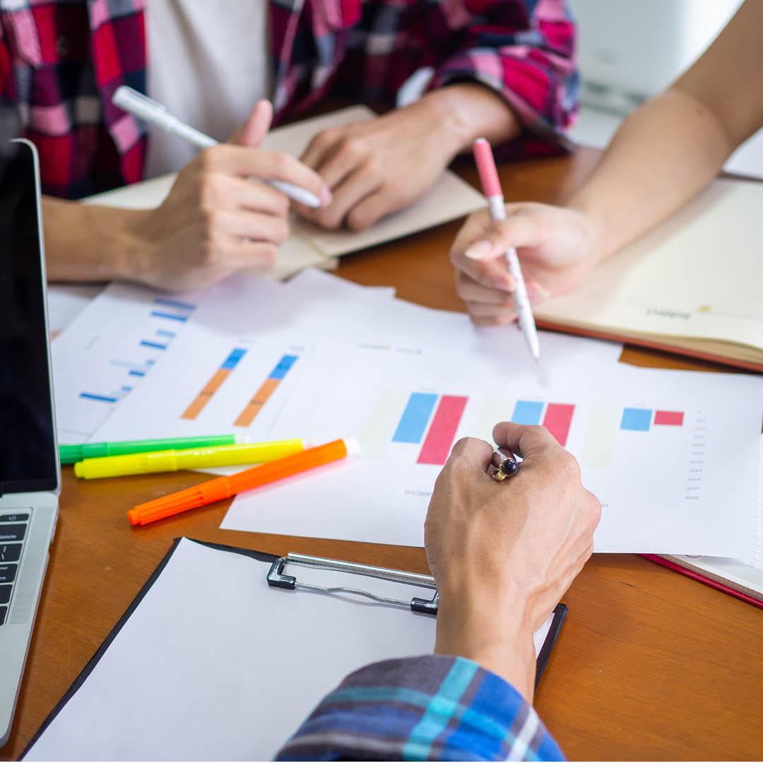 students around table studying chart